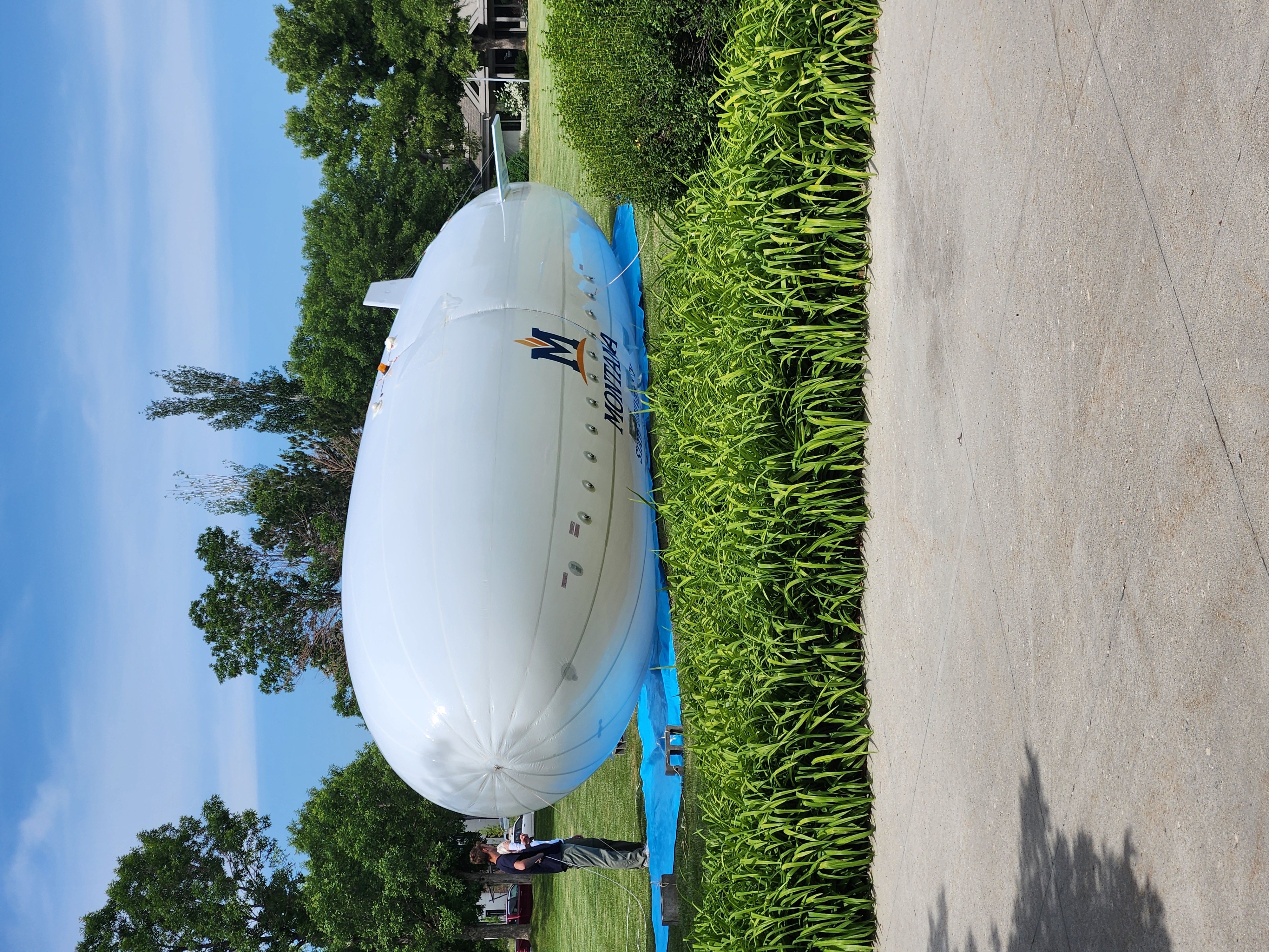 Blimp with MSU logo sitting in a field