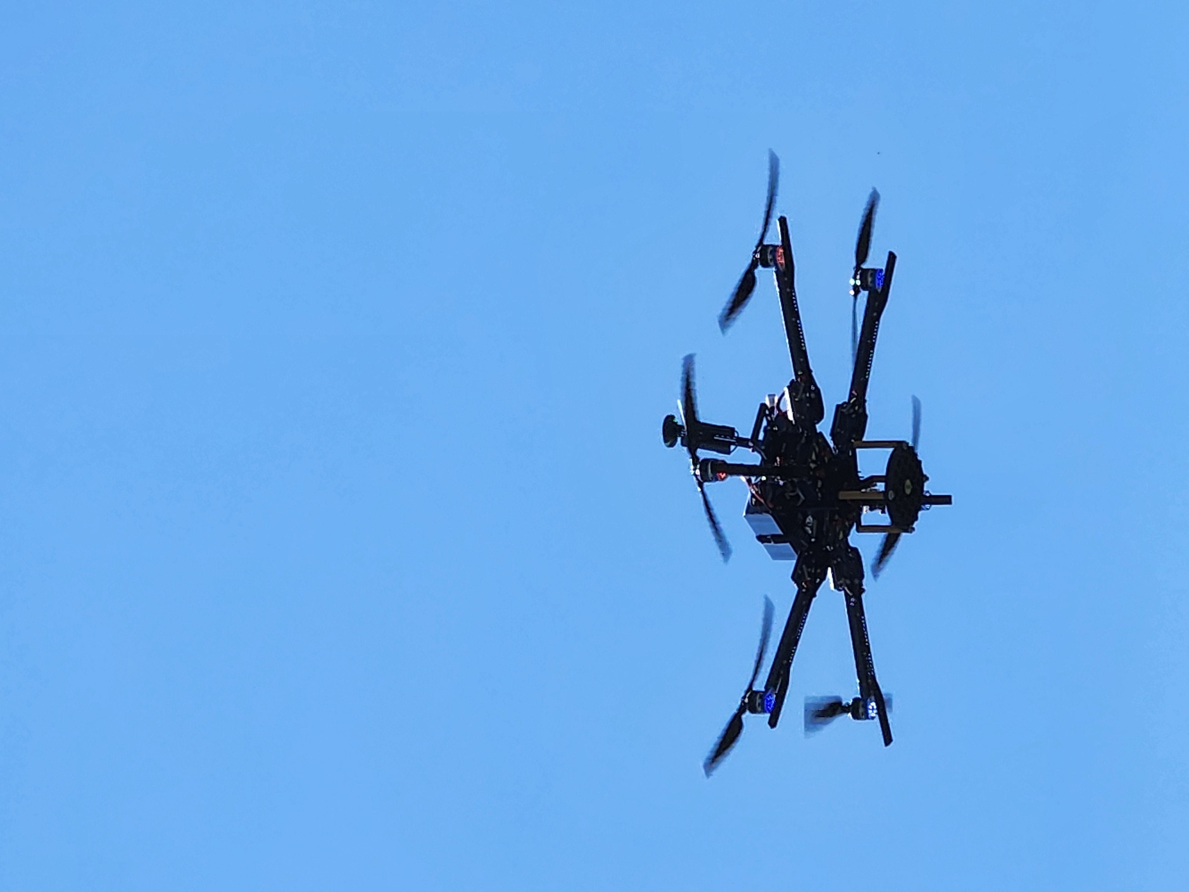 Drone flying against a blue sky