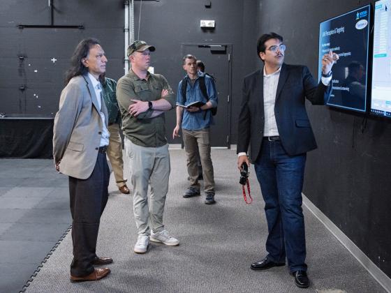 Zachery Lakin presents to Secretary of the Army Dan Driscoll and Director of Spectrum Lab Krishna Rupavatharam