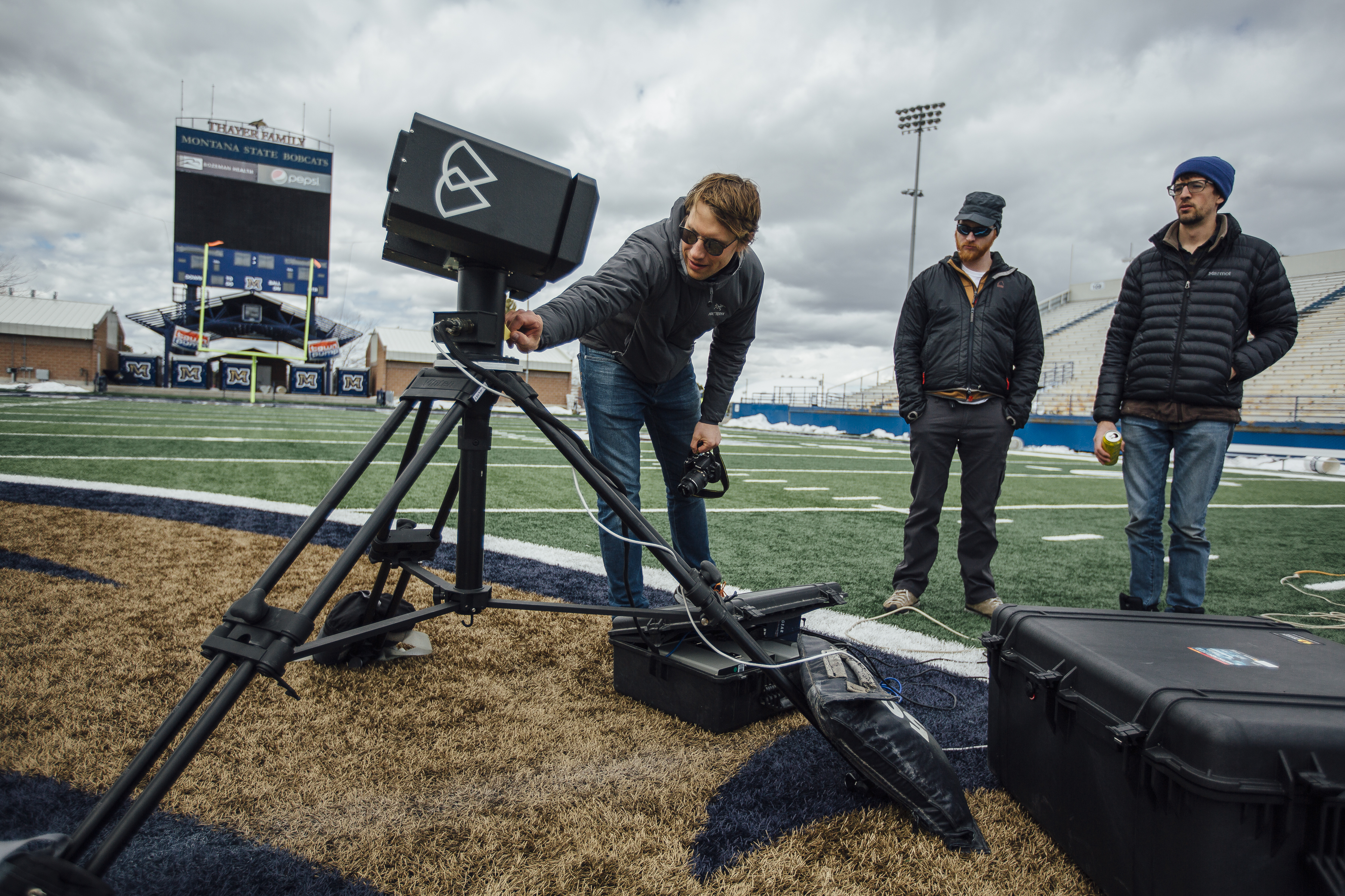 Stephen Crouch, left, co-founder of Bozeman-based Blackmore Sensors and Analytics and alumnus of MSU's Spectrum Lab, tests a lidar prototype with colleagues at the MSU stadium on April 10, 2018. MSU Photo by Adrian Sanchez-Gonzalez