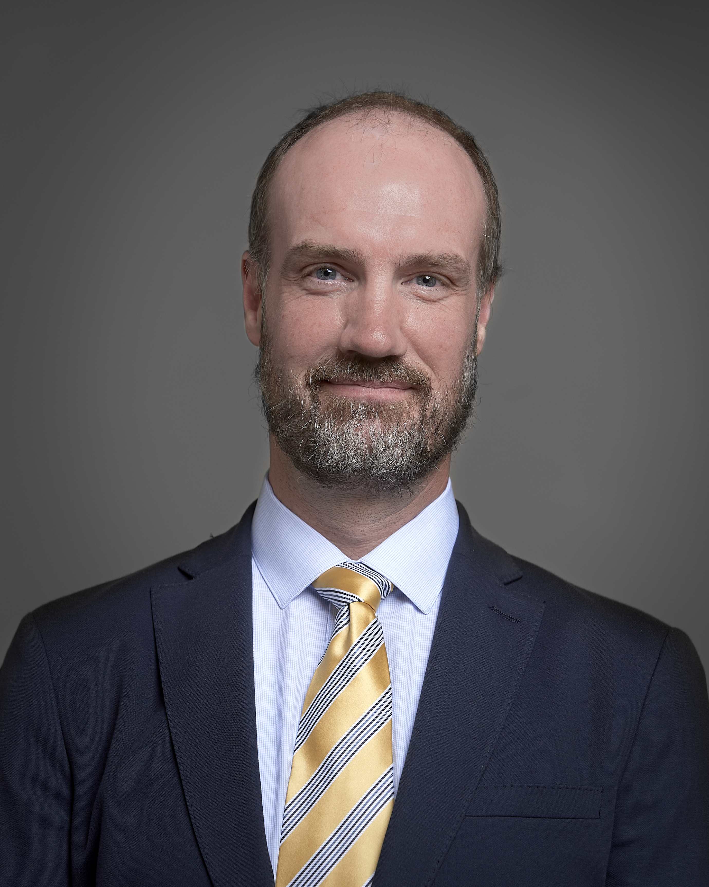 Staff headshot of Tom Rust